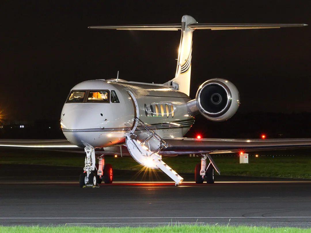 prestwick-aviation-services-Parked-executive-jet-with-doors-open-at-night
